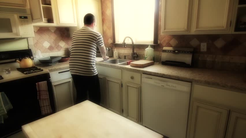Man Cleans Kitchen