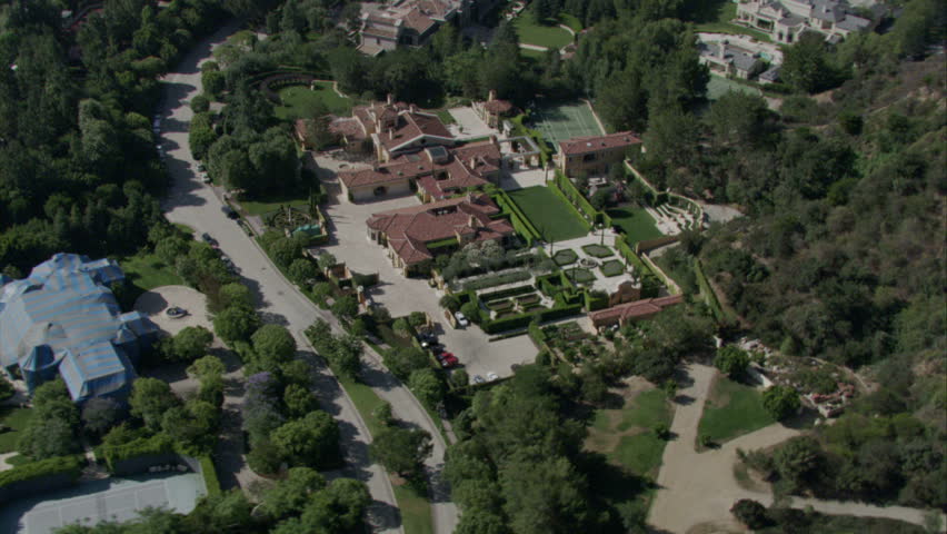 aerial shot of mansions in an elite neighborhood with expansive lots and manicured foliage circa 2009