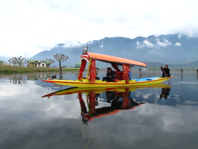 SRINAGAR, INDIA - APRIL 14: Shikara boat man singing for his customer on April 14, 2012 in Dal Lake, Srinagar, Jammu and Kashmir, India.