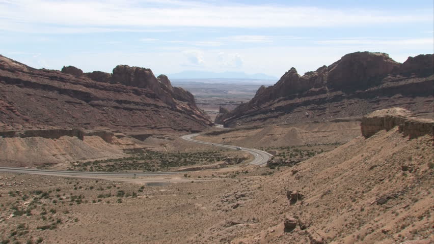 Zoom in of Spotted Wolf Canyon along I-70 inter state freeway in southern Utah. Steep rugged cut through the San Rafael Swell. Highway turns and wonders around rocks, cliffs and high mountain passes.