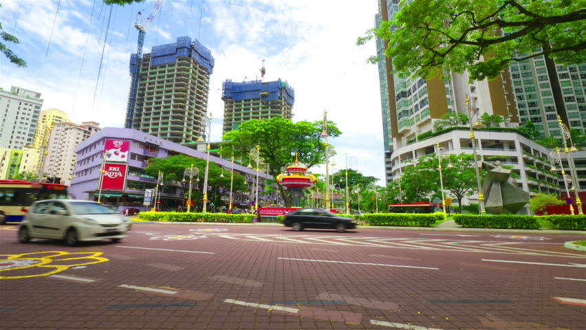 KUALA LUMPUR - MAY 5: Time lapse in motion view of traffic and pedestrians on busy intersection in Little India area of Kuala Lumpur, Malaysia on May 5, 2012.