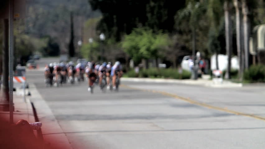 California - Circa 2009: A bike race in 2009. Peloton travels along the street in California.