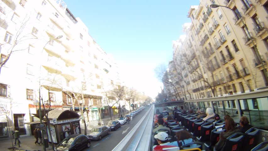 MADRID - MAR 11: (Timelapse View) Passengers go on streets of city in open bus, on Mar 11, 2012 in Madrid, Spain