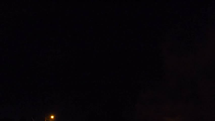 Fourth of July celebration in neighborhood streets with people lighting off fireworks.