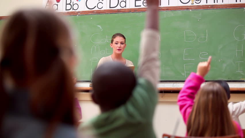 Peaceful pupils raising their arms n the classroom