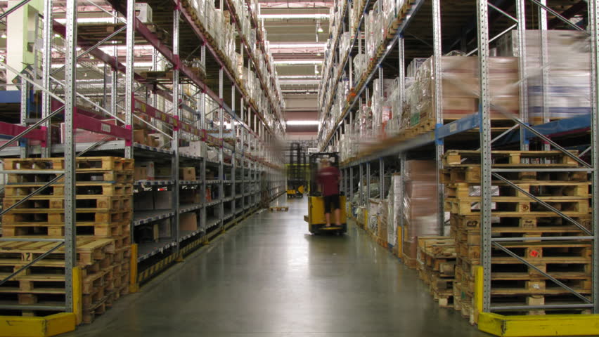 Forklifts moving in a warehouse