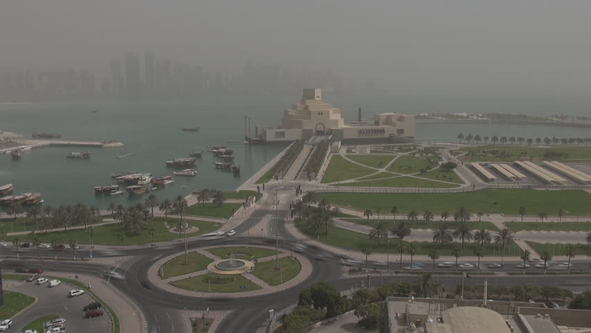 Timelapse of Museum of Islamic Art and traffic car by day in Doha, Qatar