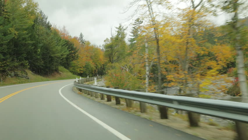 3 clips driving along the Swift River on the Kancamagus (Kanc) Highway during Autumn in the White Mountains of New Hampshire; POV is angled right off of road.