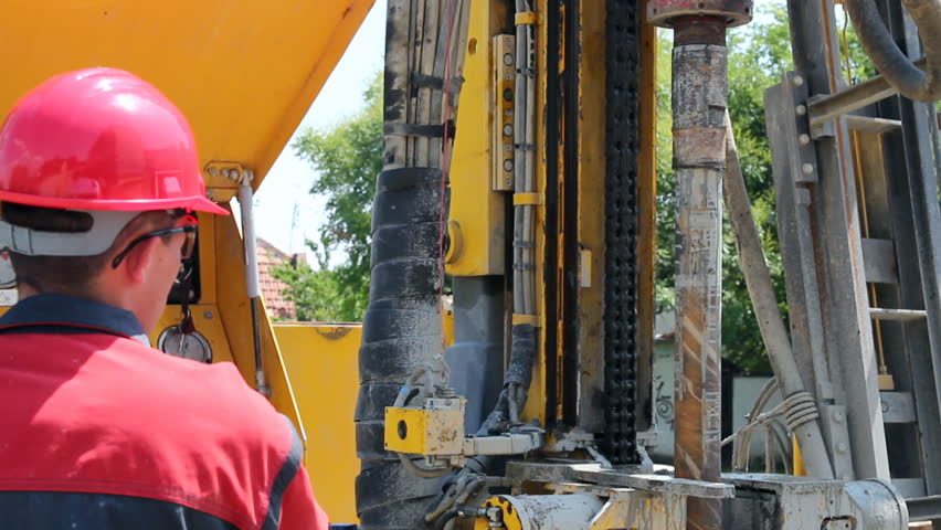 Worker operating machinery on oil rig. HD1080p. 