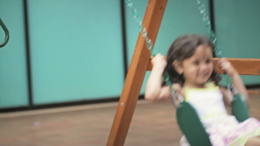 Little girl on swing close up