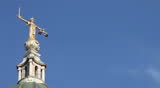 Lady Justice statue, Old Bailey, London - time lapse footage of clouds streaming by the iconic London landmark on a bright sunny day.  Copy space available.