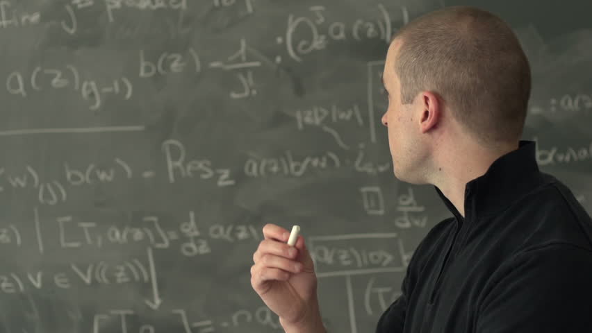 Proud teacher standing in front of chalk board