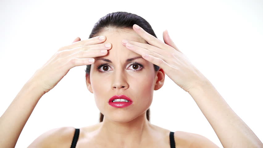 Woman checking her wrinkles on her forehead