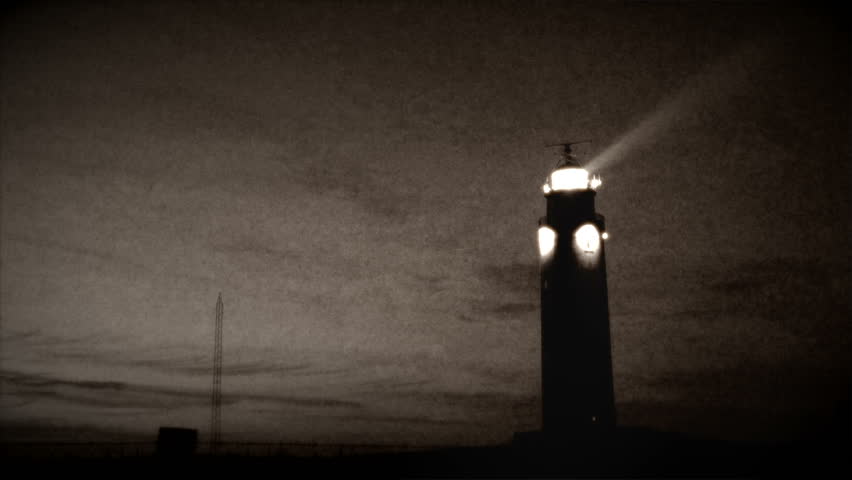 Vintage style footage of a lighthouse with turning light beam.