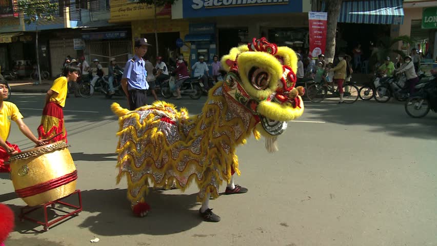 MY THO, VIETNAM - CIRCA 2010: Dragon Dance lions dancing in street in My Tho