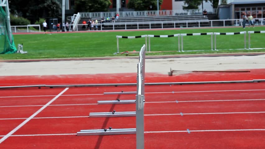 loop and slow motion of female sprinter jumping over the hurdle