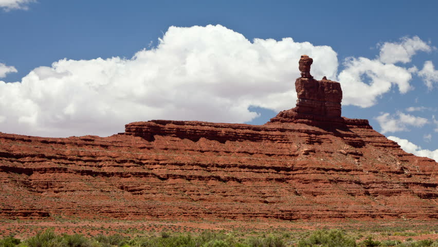 A time lapse of clouds behind a rock structure. Valley of the Gods, Utah.