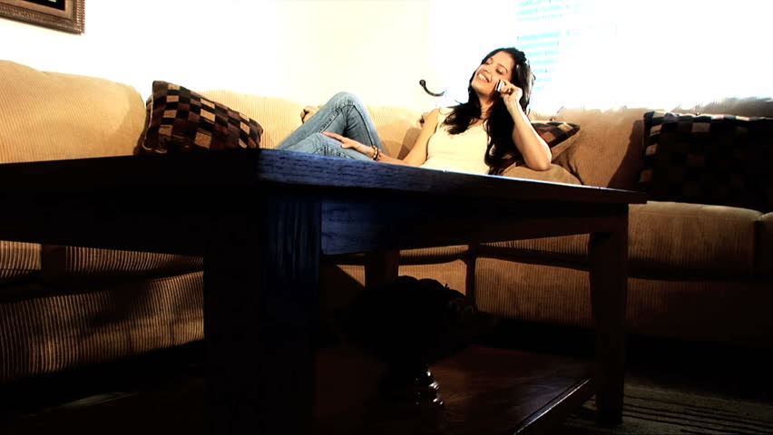 Beautiful latino girl works from home with her mobile phone