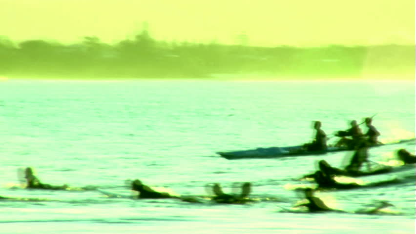 Party Wave - Multiple Surfers, Rowers, Surfski Surfing - Lots of surfers and other watercraft take off on a single wave, looking into the late afternoon setting sun.