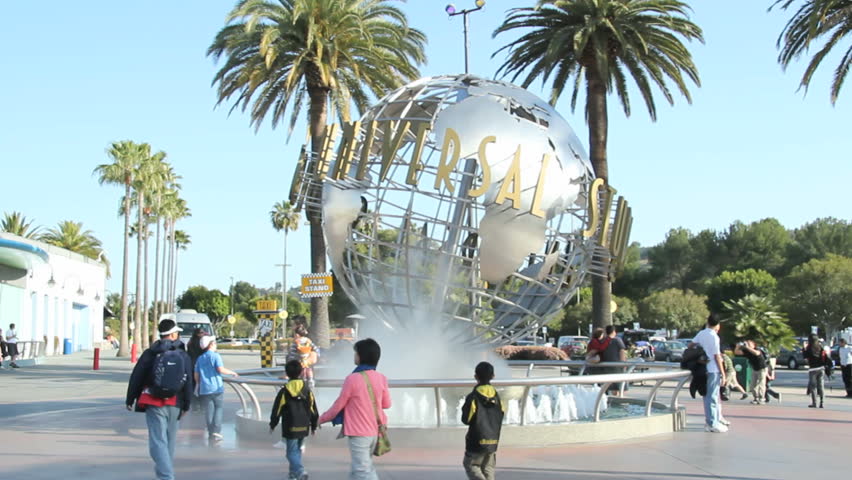 LOS ANGELES - APRIL 12: Tourists and Universal Studios' theme park visitors taking pictures of the large rotating globe fountain in front of Universal Studios on April 12, 2012 in Los Angeles, CA.