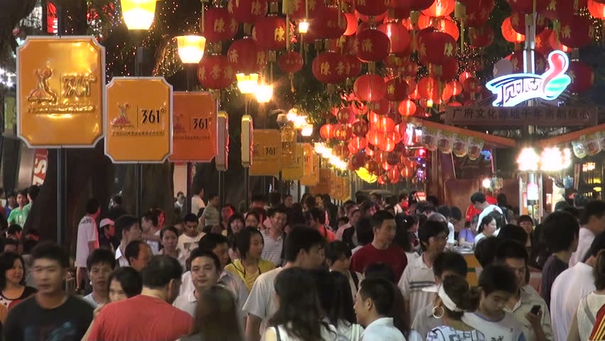 GUANGZHOU - AUGUST 9 2010: Chinese people are walking through a busy shopping street in Guangzhou