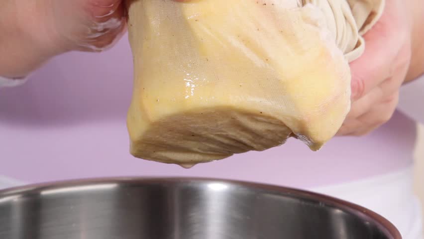 Squeezing out bag containing orange pith and pips