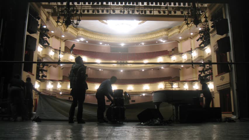 Working scenes dismantle scenery after performance in theatre, time lapse