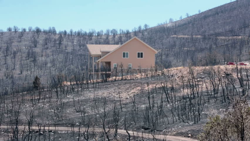 INDIANOLA, SANPETE, UTAH 3 JUL 2012: Home survives deadly mountain wildfire. Charred burnt homes and business. Blaze destroyed dozens of homes. Wood Hollow Utah. FEMA Federal Government assistance. 