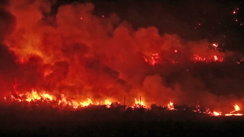 Forest fire burns out of control night in Wood Hollow Canyon.  Flames burning on mountain  rural town in central Utah Sanpete County. Strong winds and very dry season results in extreme fire danger
