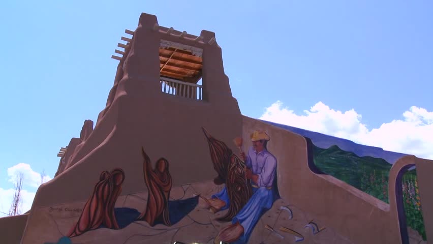 TAOS, N.M. - CIRCA 2010 - A mural adorns a traditional adobe building in Taos, New Mexico. 