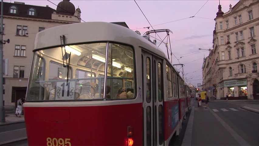 Prague, Czech Republic - CIRCA July, 2006: A tram passes the camera and heads down the street during dusk