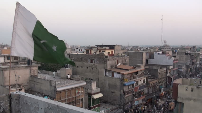 The flag of Pakistan is waving in front of the 'skyline' of Rawalpindi