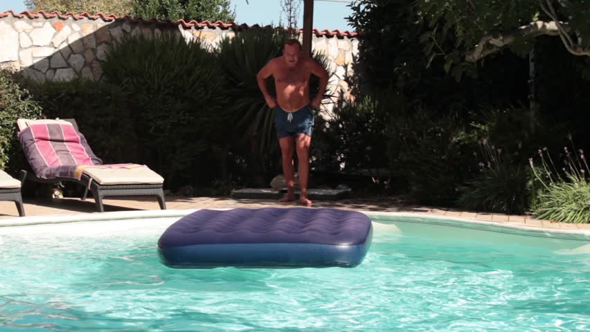 Funny Man Jumping. Video of funny man jumping on water mat in the swimming pool.