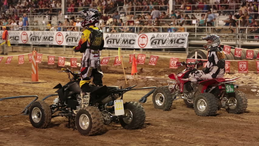 NEPHI, JUAB, UTAH 30 JUN 2012: Economic boost to rural community in annual race. Motocross ATV at starting line crowd. Juab County extreme enduro. Spectators watching from stands.