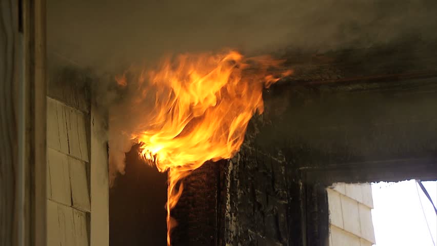 Flames coming out window of house on fire