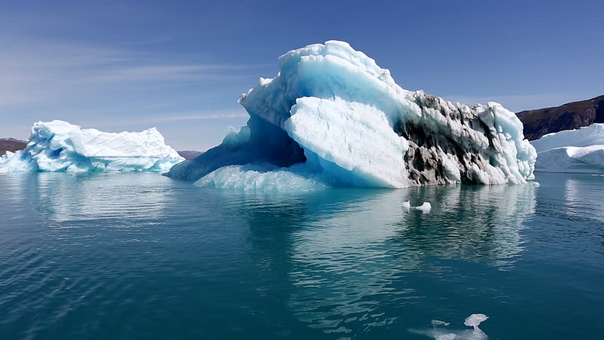 Drifting by an iceberg floating in Qooroq Icefjord, South Greenland