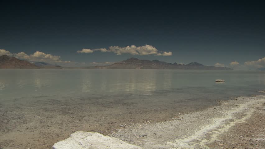 Salty shores of the Great Salt Lake with blue skies and clouds