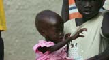BOR, SOUTH SUDAN - JUNE 26: Starving child is held by her sister on June 26, 2011 in Bor, South Sudan. Conditions in South Sudan have gotten significantly worse since Independence in January 2011.