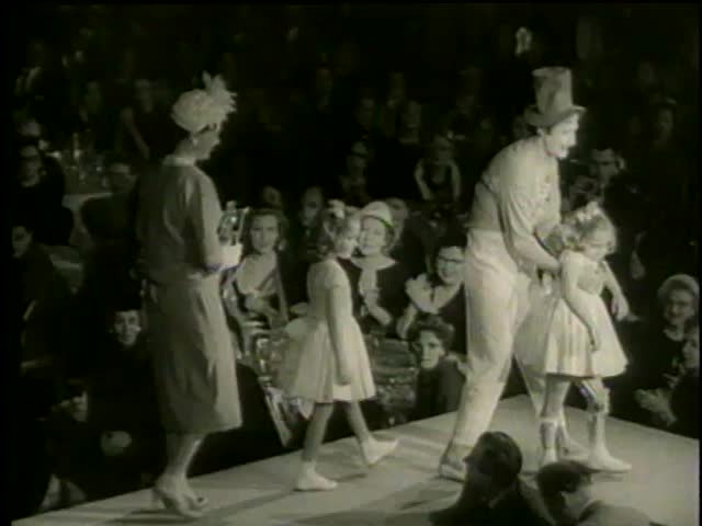 Marcel Marceau and twins, Sandy and Lindy Solomon, walk on runaway at Gala Style Show for March of Dimes in New York circa 1958 - MGM PICTURES, UNIVERSAL-INTERNATIONAL NEWSREEL, USA, filmed in 1958