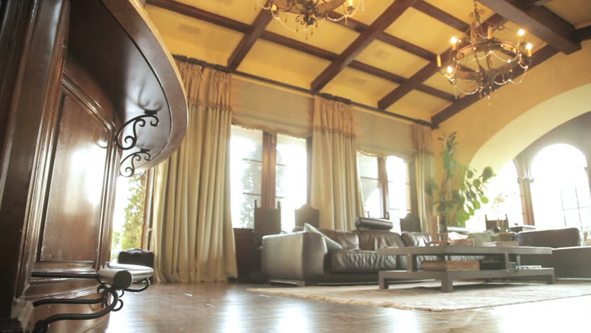 Panning shot of a sitting room in an expensive home showing ceiling