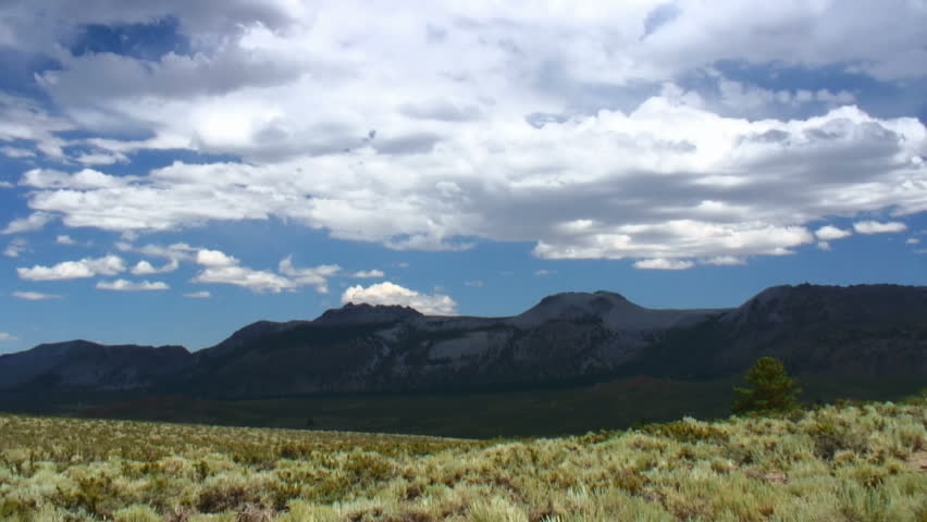 Clouds and shadows race over sagebrush and the Mono Craters 