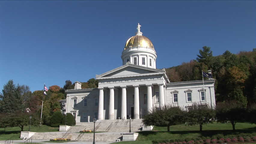 Montpelier, Vermont - CIRCA September 2007: Wide view of the State Capitol Building sitting on a green lawn with trees during the day