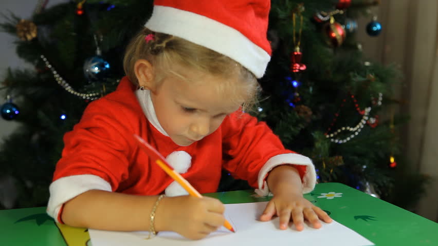 Child Writing a Letter to Santa Claus by Christmas Tree, Little Girl Dressed in Santa Claus Near Christmas Tree