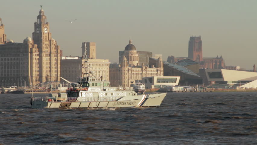 UK Border Agency vessel passing in front of Liverpool skyline