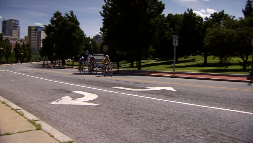 PROVIDENCE, RHODE ISLAND - SEPTEMBER 3, 2009: Three bicycle racers on city street passing camera on tight turn