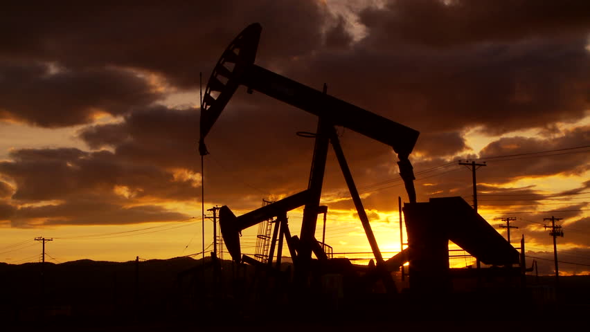 Oil well piston pumps at sunset