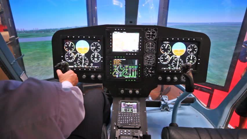 Pilot operates helicopter simulator on exhibition of helicopter industry
