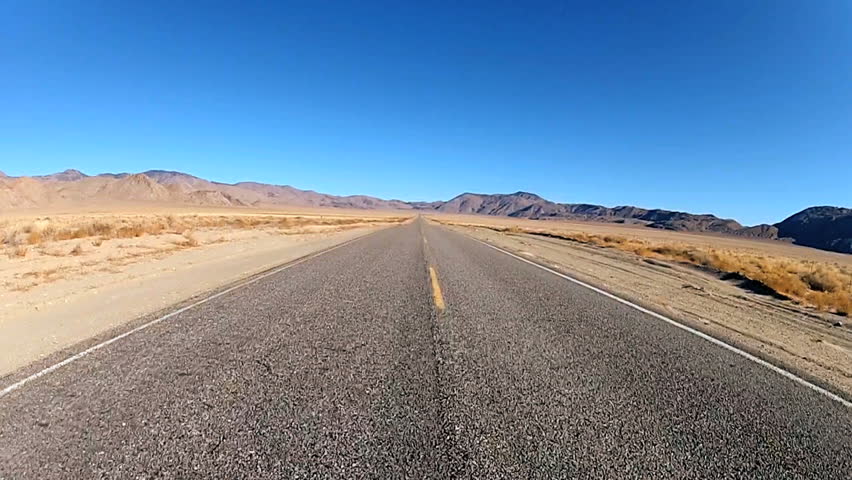 Point of view driving on desert highway, USA