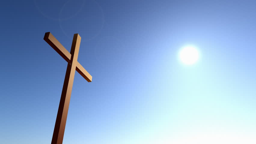 Christian cross against a dawn time lapse sky.