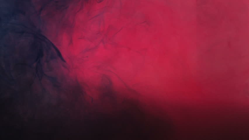 Blue food coloring floating and morphing underwater with red light